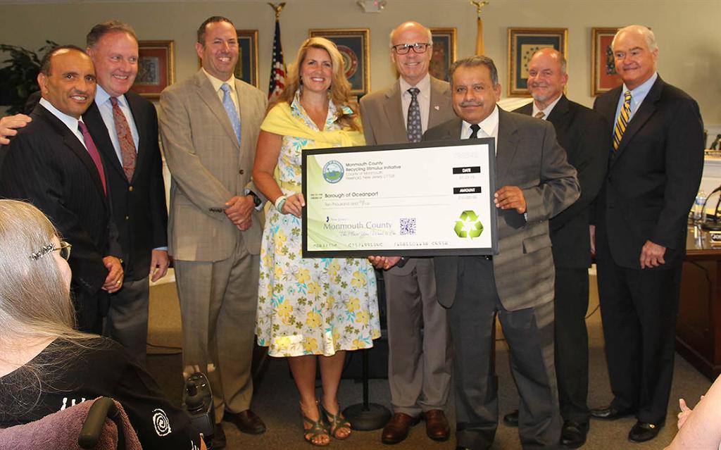 The Monmouth County Board of Chosen Freeholders and the Monmouth County Clean Communities staff present a $10,000 Recycling Stimulus Initiative grant to Oceanport at their regular public meeting on July 23 in West Long Branch, NJ. Pictured left to right: Freeholder Thomas A. Arnone, William Johnson, Stuart Newman, Freeholder Deputy Director Serena DiMaso, Freeholder Director Gary J. Rich, Sr., Oceanport Public Works Foreman and Recycling Coordinator Demetrio Zarate, Richard Throckmorton and Freeholder John P. Curley.